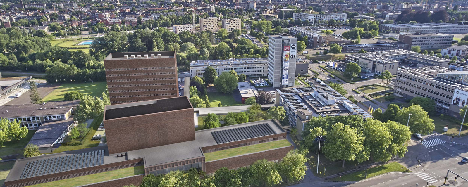 Luchtfoto van een stedelijk gebied met groene bomen en verschillende gebouwen.