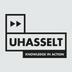 UHasselt logo met zwarte tekst en dubbele pijl, witte achtergrond.